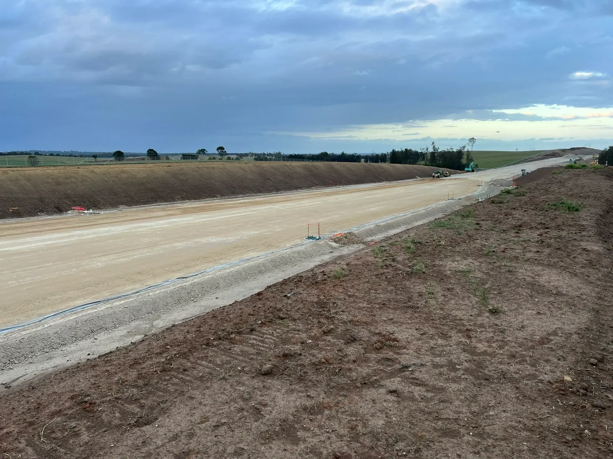 Civil construction earthworks on a major road corridor at dusk